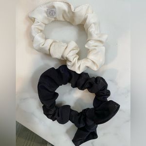 Two lululemon uplifting scrunchies. 1 black camo and one white
